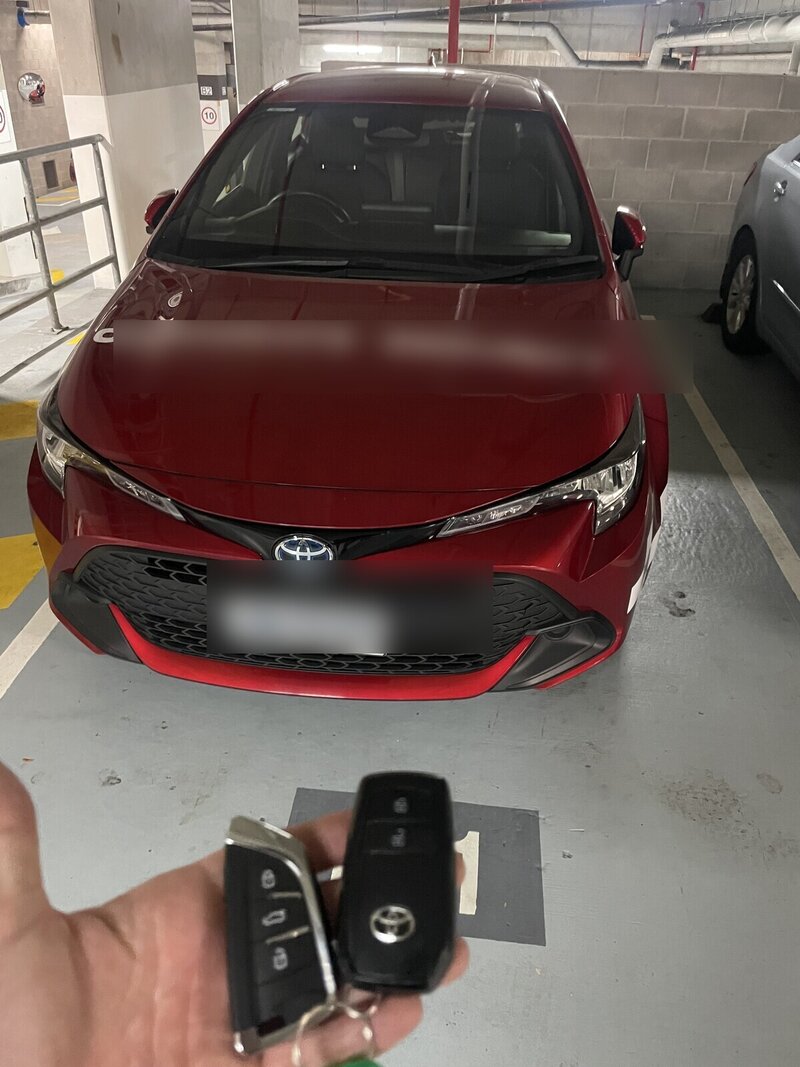 Two programmed smart keys in hand next to a fleet vehicle — proximity key replacement completed on-site for a Gold Coast commercial client